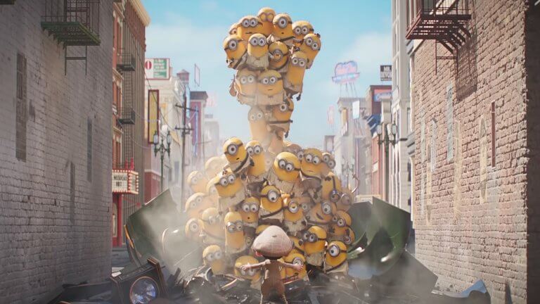 Minions & Monsters: viele kleine Minions bauen sich zu einer Wand auf. Vor ihnen steht eine kleine Person mit Mütze, die offensichtlich versucht, die Minions aufzuhalten.