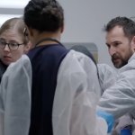 The Pitt: die Ärzte sind über einen Patienten gebeugt und versuchen, ihm das Leben zu retten.