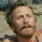 Die Fahrten des Odysseus: Kirk Douglas sitzt erschöpft am Strand und blickt in die Ferne.